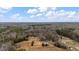 Aerial view showcasing the expansive wooded lot and surrounding landscape at 2232 Miller Rd, Hillsborough, NC 27278