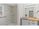 This bathroom includes tiled walls, a modern vanity, and a large mirror at 2232 Miller Rd, Hillsborough, NC 27278