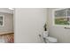 This bathroom features a toilet and a window view at 2232 Miller Rd, Hillsborough, NC 27278