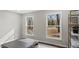 Neutral bedroom with a gray accent wall and natural lighting at 2232 Miller Rd, Hillsborough, NC 27278