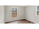 Bedroom featuring wood-look floors, neutral walls, board and batten and a window with a backyard view at 2232 Miller Rd, Hillsborough, NC 27278