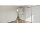 Bedroom with wood-look flooring, neutral walls, and access to an ensuite bathroom and closet at 2232 Miller Rd, Hillsborough, NC 27278