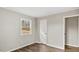Bedroom with wood-look flooring, neutral walls, and a window with a backyard view at 2232 Miller Rd, Hillsborough, NC 27278
