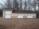 Three car garage with white doors and neutral colored exterior at 2232 Miller Rd, Hillsborough, NC 27278