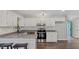 Modern kitchen featuring granite countertops and a suite of stainless steel appliances at 2232 Miller Rd, Hillsborough, NC 27278
