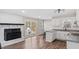 An open kitchen with a fireplace and white cabinetry at 2232 Miller Rd, Hillsborough, NC 27278