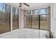 Bright sunroom with large windows offering natural light and views of the wooded property at 2232 Miller Rd, Hillsborough, NC 27278