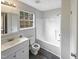 Bathroom with white tile and updated fixtures, next to a window that brings in natural light at 26 Malbry Pl, Durham, NC 27704