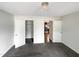 Bedroom with a modern light fixture, spacious closet, and a doorway leading into another room at 26 Malbry Pl, Durham, NC 27704