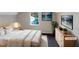 Comfortable bedroom with a large bed, light colored walls, and bright light from the window at 26 Malbry Pl, Durham, NC 27704