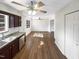 Open living area featuring dark cabinets in the kitchen and hardwood floors throughout at 26 Malbry Pl, Durham, NC 27704