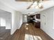 Open living area featuring dark cabinets in the kitchen and hardwood floors throughout at 26 Malbry Pl, Durham, NC 27704