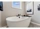 Relaxing bathroom featuring a soaking tub with stylish fixtures and a serene ambiance at 2644 Catheys Creek Cir, Wendell, NC 27591