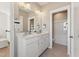 Bright bathroom featuring a double vanity, neutral color scheme, and tiled flooring for a clean aesthetic at 2644 Catheys Creek Cir, Wendell, NC 27591