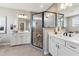 Elegant bathroom with double vanities, a glass-enclosed shower, and tile flooring at 2644 Catheys Creek Cir, Wendell, NC 27591