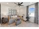 Charming bedroom features stylish decor, a daybed with decorative pillows and a modern ceiling fan at 2644 Catheys Creek Cir, Wendell, NC 27591