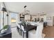 Bright dining area with modern lighting open to gourmet kitchen with island seating at 2644 Catheys Creek Cir, Wendell, NC 27591