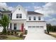 Charming two-story home featuring a bright red front door and a two-car garage at 2644 Catheys Creek Cir, Wendell, NC 27591