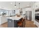 Modern kitchen featuring white cabinetry, stainless steel appliances, and a spacious island with bar seating at 2644 Catheys Creek Cir, Wendell, NC 27591