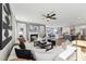 Open-concept living room with fireplace, modern decor, and abundant natural light at 2644 Catheys Creek Cir, Wendell, NC 27591