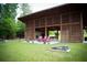 Open-air pavilion featuring a stone fireplace and comfortable seating, perfect for outdoor gatherings and relaxation at 2644 Catheys Creek Cir, Wendell, NC 27591