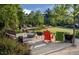 Outdoor common area featuring fire pit, seating, and lush landscaping at 2800 Kempthone Rd # 65, Cary, NC 27519