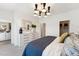 Bright main bedroom features modern light fixture, dresser and mirror, plus walk-in closet at 2800 Kempthone Rd # 65, Cary, NC 27519