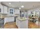 Kitchen with granite countertops, stainless steel appliances, and island, opening to dining area at 2938 Suncrest Village Ln, Raleigh, NC 27616