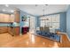 Dining room boasts natural light, table with seating for six, blue walls, and hardwood floors at 3116 Kentish Town Ln, Raleigh, NC 27612