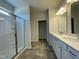 Bright bathroom featuring a double vanity, large mirror, and walk-in glass shower at 316 Olivia Crossing Ct # 11, Four Oaks, NC 27524
