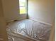 Bedroom with a large window providing natural light and exterior views, and carpet flooring at 316 Olivia Crossing Ct # 11, Four Oaks, NC 27524