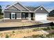Charming single-Gathering home with gray siding, white trim, a covered porch, and a two-car garage at 316 Olivia Crossing Ct # 11, Four Oaks, NC 27524