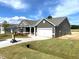 New construction, single-story home with an attached garage and freshly laid sod at 316 Olivia Crossing Ct # 11, Four Oaks, NC 27524