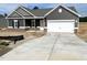 Charming single-Gathering home featuring a two-car garage, gray siding, and a welcoming front porch at 316 Olivia Crossing Ct # 11, Four Oaks, NC 27524