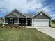 Beautiful single-story home with gray siding, white trim, a two-car garage, and green lawn at 316 Olivia Crossing Ct # 11, Four Oaks, NC 27524