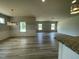 Spacious living room featuring wood-look floors and ample natural light from several windows at 316 Olivia Crossing Ct # 11, Four Oaks, NC 27524