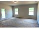 Bright living room with backyard access and natural light streaming through windows at 316 Olivia Crossing Ct # 11, Four Oaks, NC 27524
