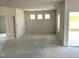 Unfinished living room with decorative molding, large windows, and an open floor plan, ready for customization at 316 Olivia Crossing Ct # 11, Four Oaks, NC 27524