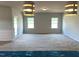 Bright, spacious living room with large windows and modern lighting fixtures at 316 Olivia Crossing Ct # 11, Four Oaks, NC 27524