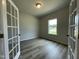 Home office with neutral walls, stylish wood-look floors, and a window for natural light at 316 Olivia Crossing Ct # 11, Four Oaks, NC 27524