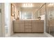 Modern bathroom featuring double sinks, a large mirror, and a walk-in shower with glass door at 322 Clementine Dr, Cary, NC 27519