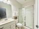 Bright full bathroom showcasing a walk-in shower with glass doors, neutral paint and updated vanity at 322 Clementine Dr, Cary, NC 27519