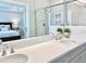 Modern bathroom with marble tile, a glass shower, and double sink vanity at 322 Clementine Dr, Cary, NC 27519