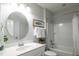 Well-lit bathroom featuring a single sink vanity, oval mirror, and a shower-tub combination at 322 Clementine Dr, Cary, NC 27519