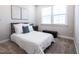 Neutral bedroom features a bed with white bedding, artwork, and large windows for natural light at 322 Clementine Dr, Cary, NC 27519