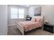 Charming bedroom features a white bed frame with a pink comforter and bright window at 322 Clementine Dr, Cary, NC 27519