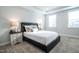 Comfortable bedroom with carpet, a large window, and bedside tables with lamps at 322 Clementine Dr, Cary, NC 27519