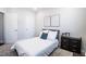 Cozy bedroom featuring a bed with decorative pillows, modern art, and a view of the room's entryways at 322 Clementine Dr, Cary, NC 27519