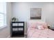 Bright bedroom featuring a white bed frame, decorative wall art, and a window with blinds at 322 Clementine Dr, Cary, NC 27519