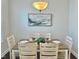 Dining area featuring light wood chairs, a table setting, and an elegant art piece at 322 Clementine Dr, Cary, NC 27519